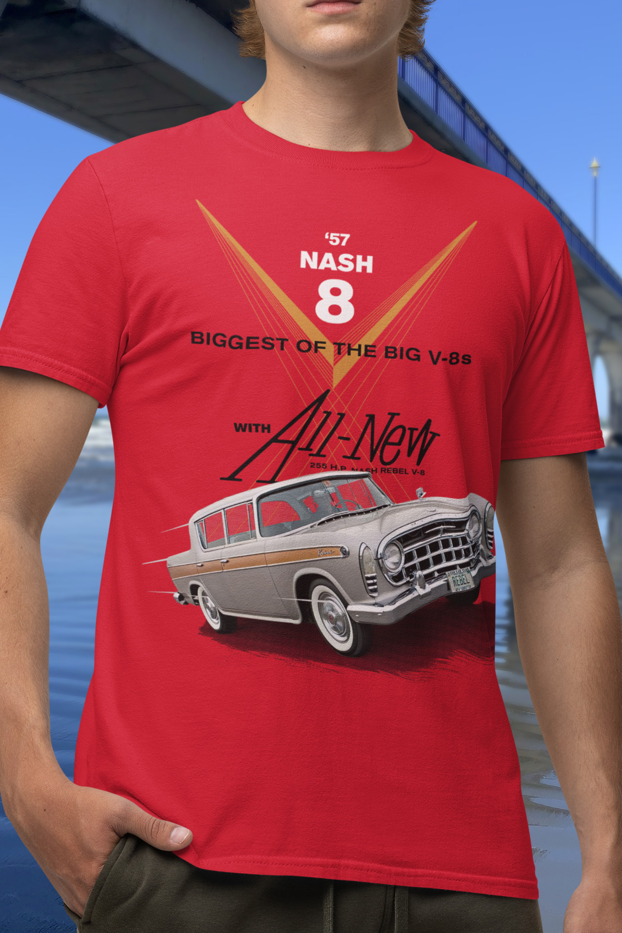 Young man in a red 1957 Rambler Rebel t-shirt standing beside New Brighton Pier.