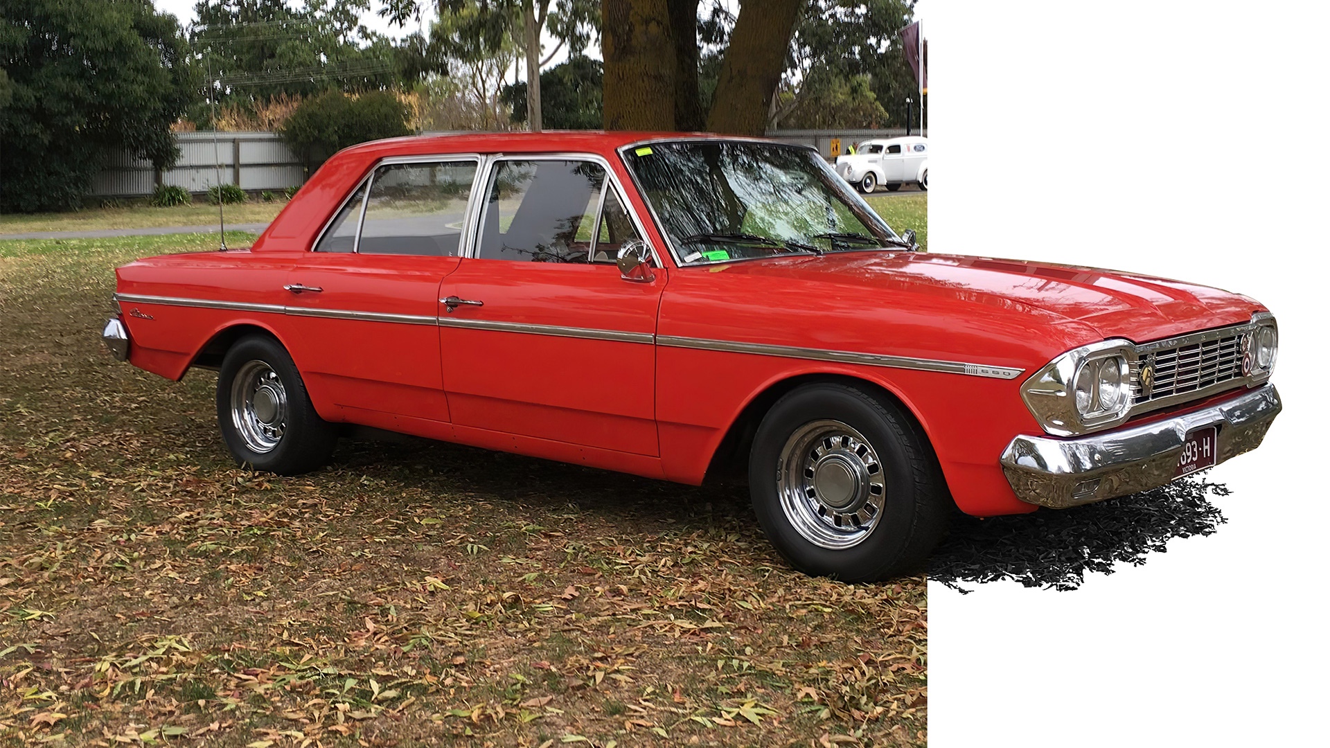 Red American Motors Rambler Classic 650 sedan parked under a Eucalyptus tree in Melbourne, Victoria, Australia.